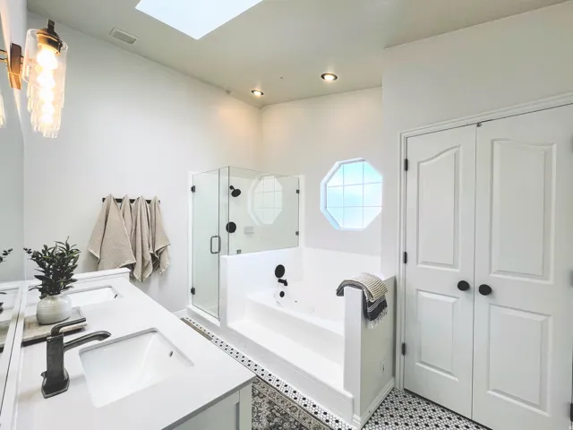White vanity with dual integrated sinks and bronze-finish fixtures