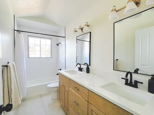 Dual vanity with wood-finish cabinetry and rectangular undermount sinks