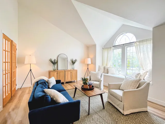 Vaulted ceilings, wood-finish flooring, French doors, a built-in window seat, and an arched transom window