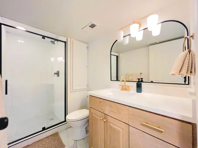 Full glass shower enclosure with black framing