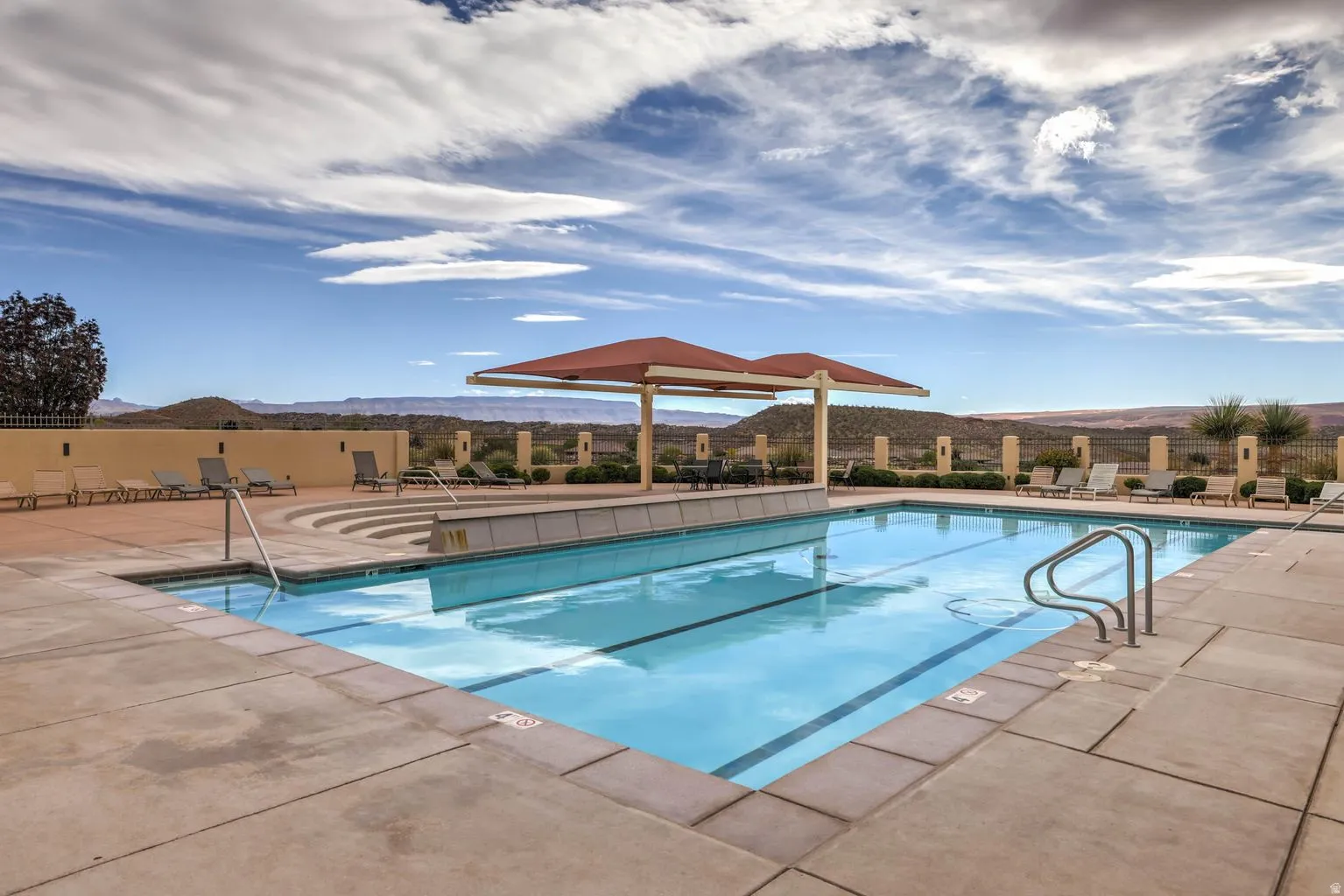 Swimming pool with integrated lane lines and a surrounding concrete deck
