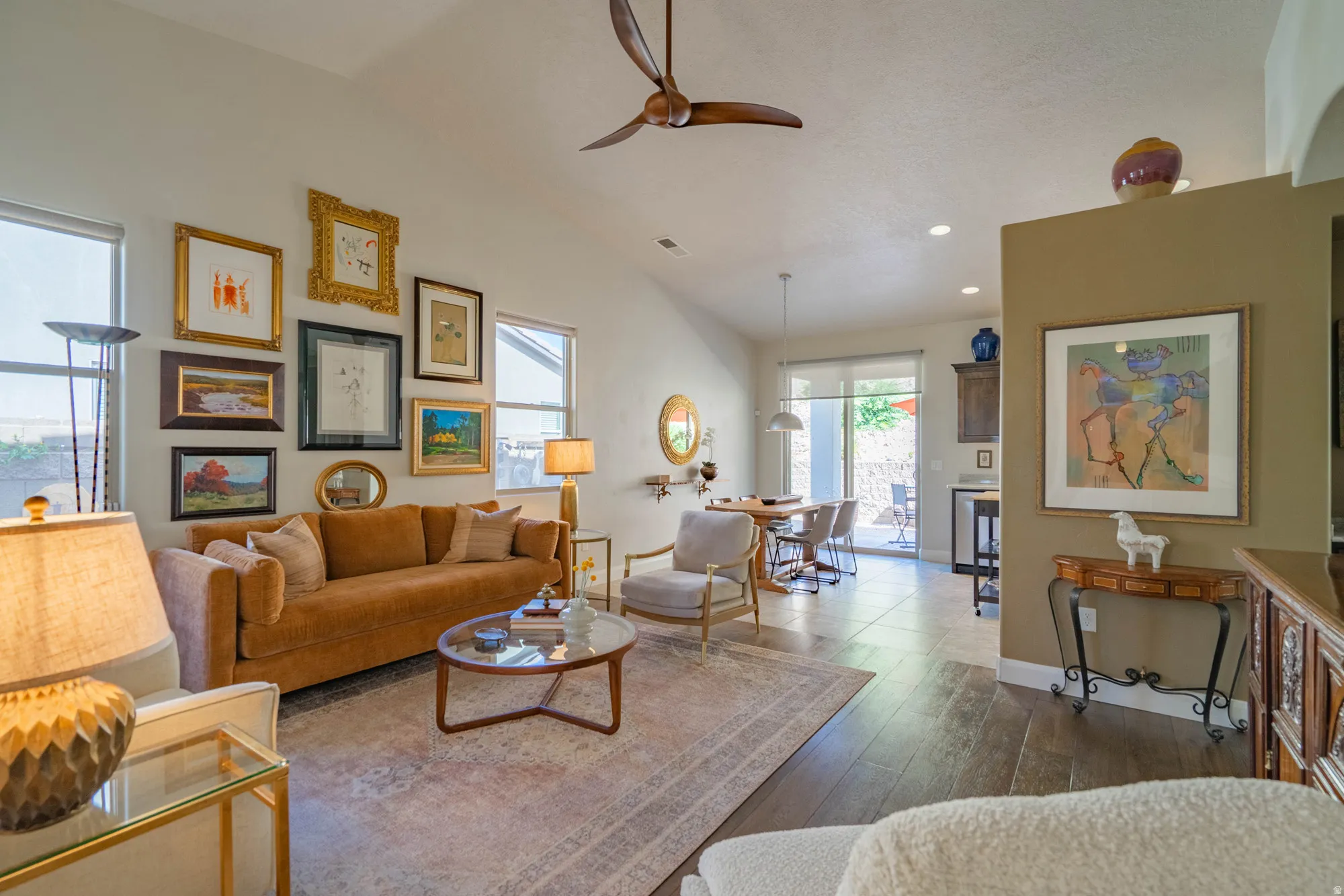 Vaulted ceiling with a ceiling fan, recessed lighting, and wood-finish flooring