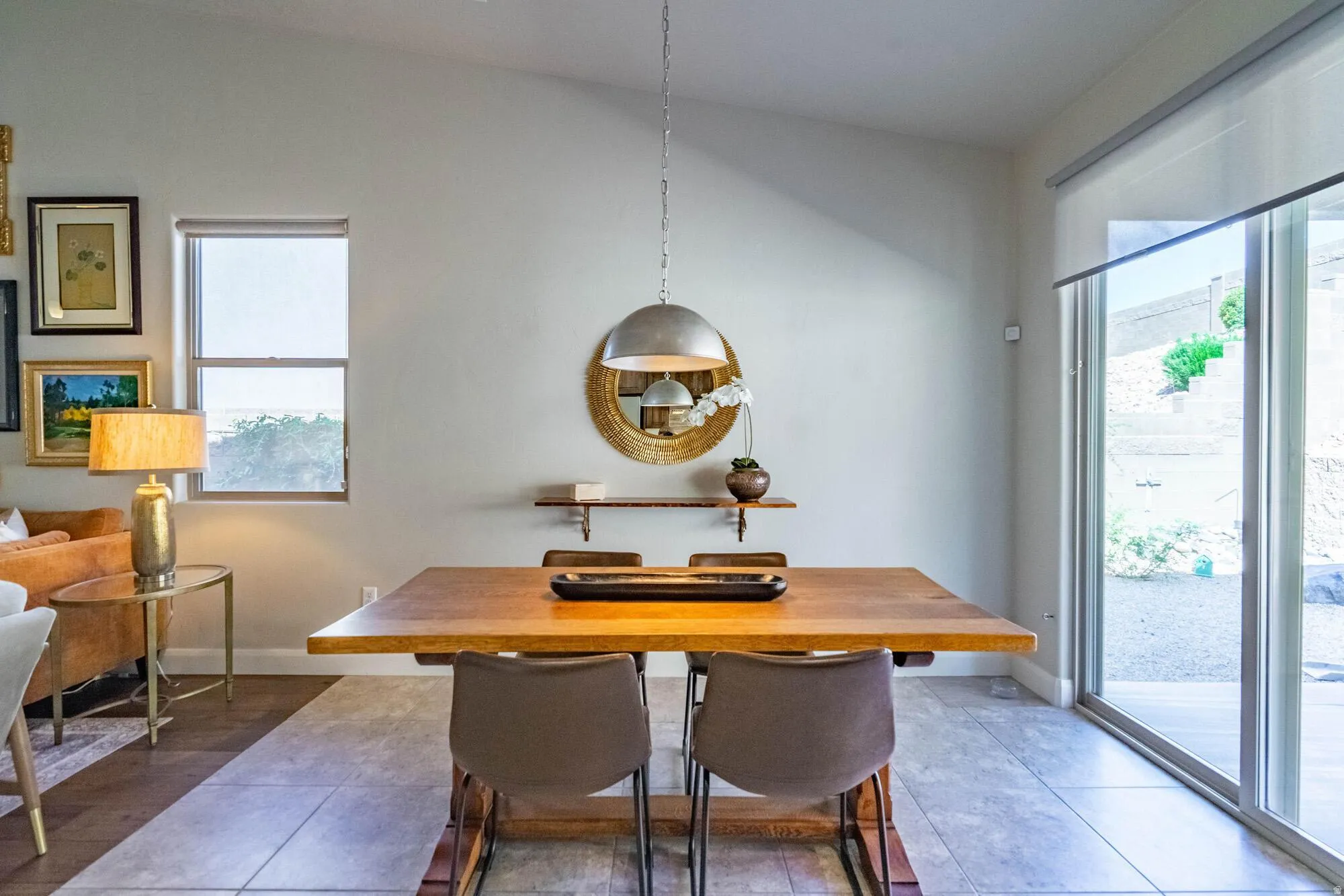 Vaulted ceiling, recessed lighting, tile flooring, wood-finish dining table, and sliding glass doors to the exterior