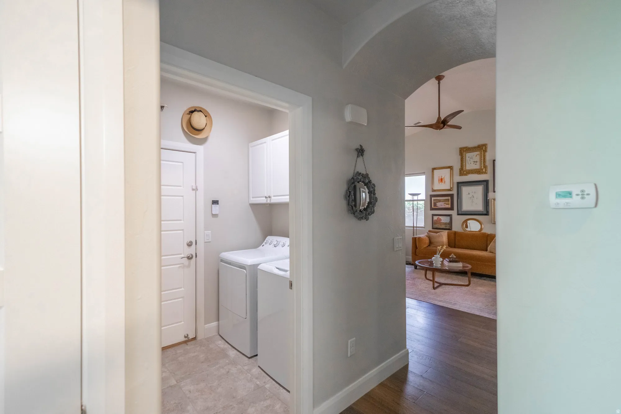 Dedicated laundry area with tile flooring and built-in white cabinetry