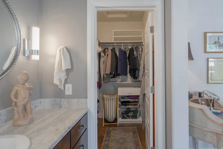 Walk-in closet with built-in shelving and hanging rods