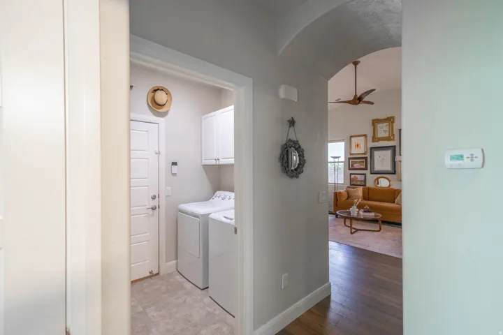 Dedicated laundry area with tile flooring and built-in white cabinetry