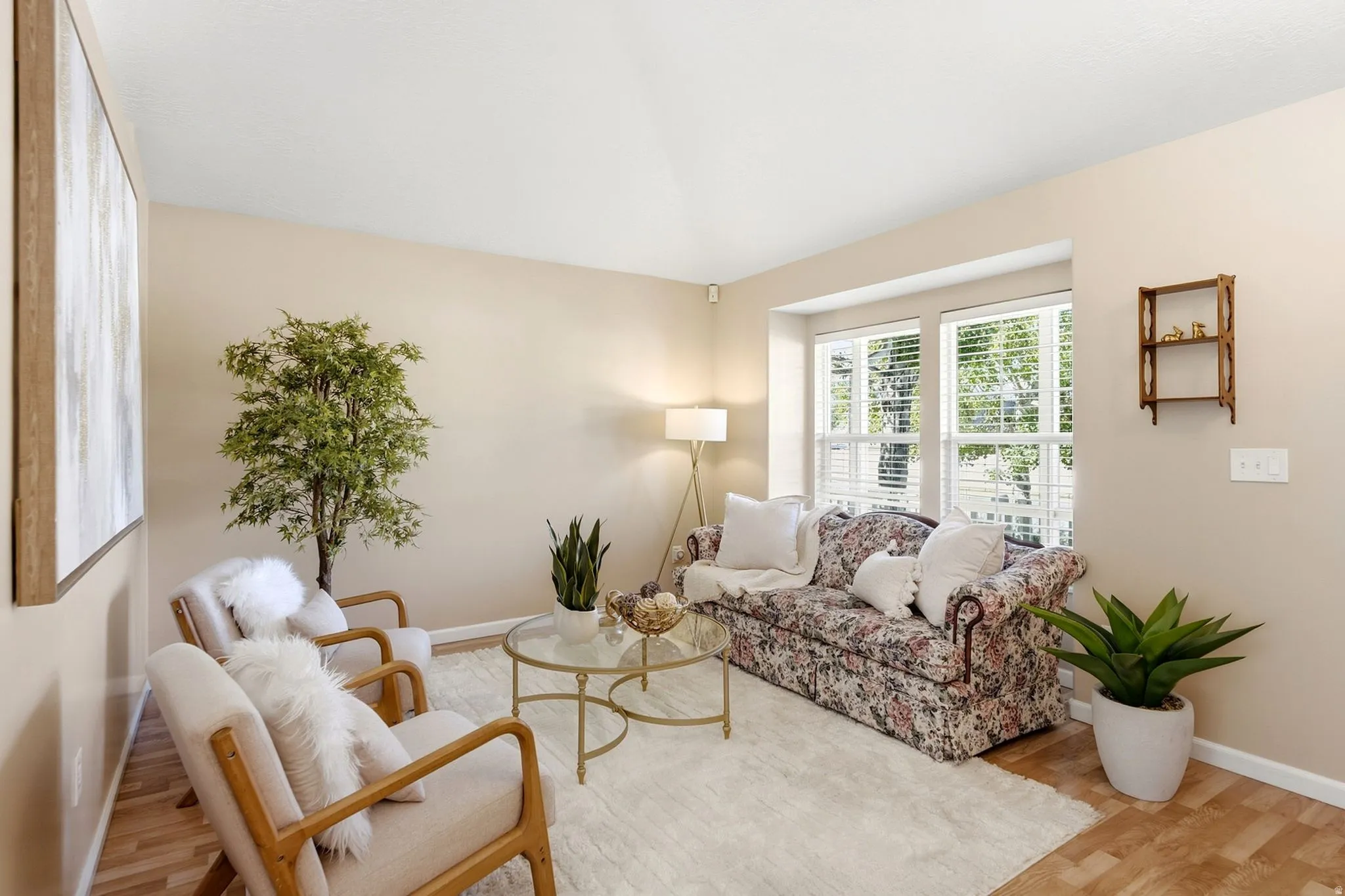 Hardwood-style flooring and huge picture window allow for an inviting ambiance