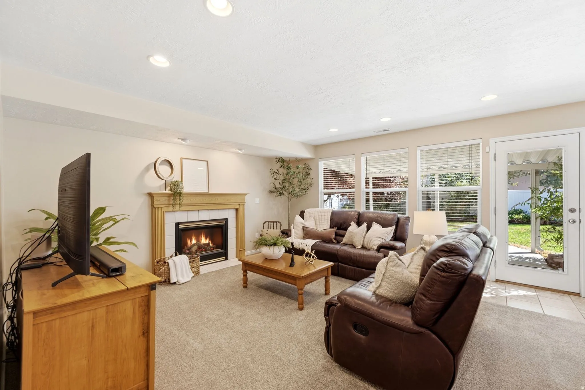 Built-in fireplace with a white tile surround and wood mantel