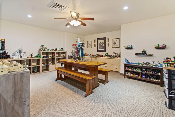 Recessed lighting, ceiling fan, built-in shelving, built-in cabinetry, and neutral carpeting