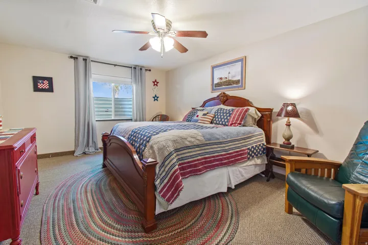 Recessed window, ceiling fan, and carpeted flooring