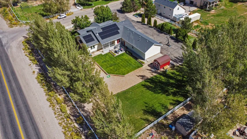 Single-story residence featuring a gray shingle roof and solar panels