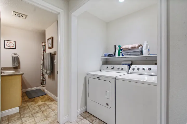 Dedicated laundry area with built-in shelving