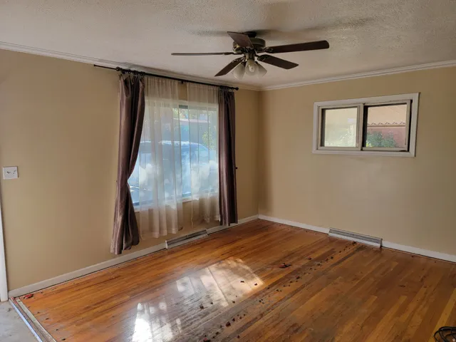Wood-finish flooring throughout, complemented by crown molding and baseboards