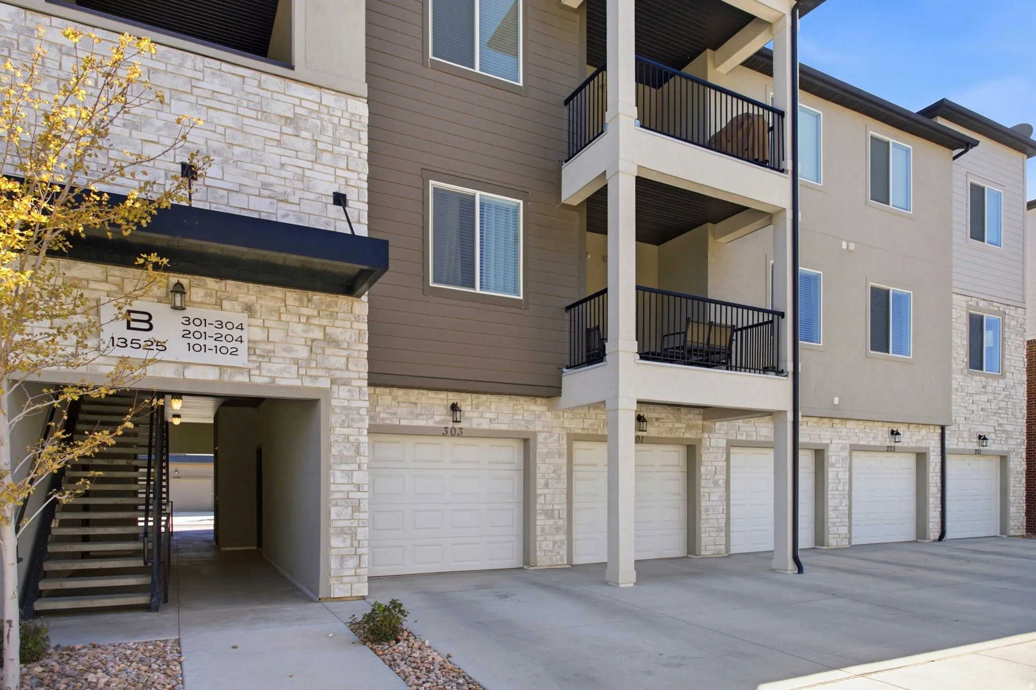 Multi-story building featuring stone veneer and horizontal siding