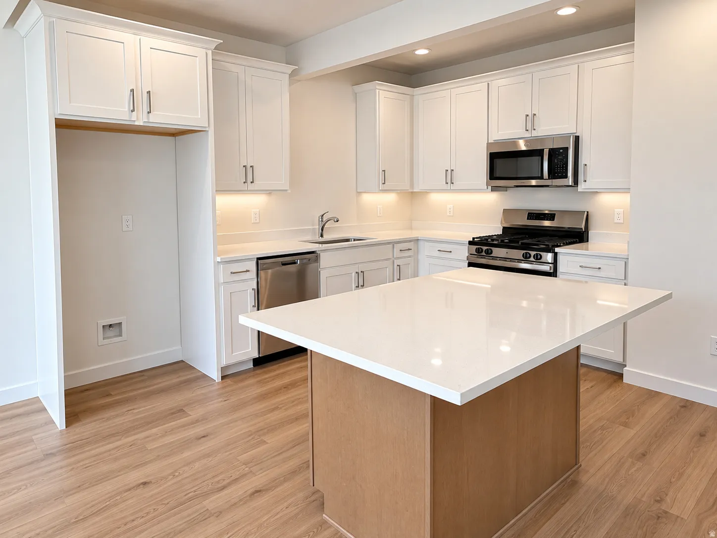 Kitchen with quartz countertops, stainless steel appliances, gas range