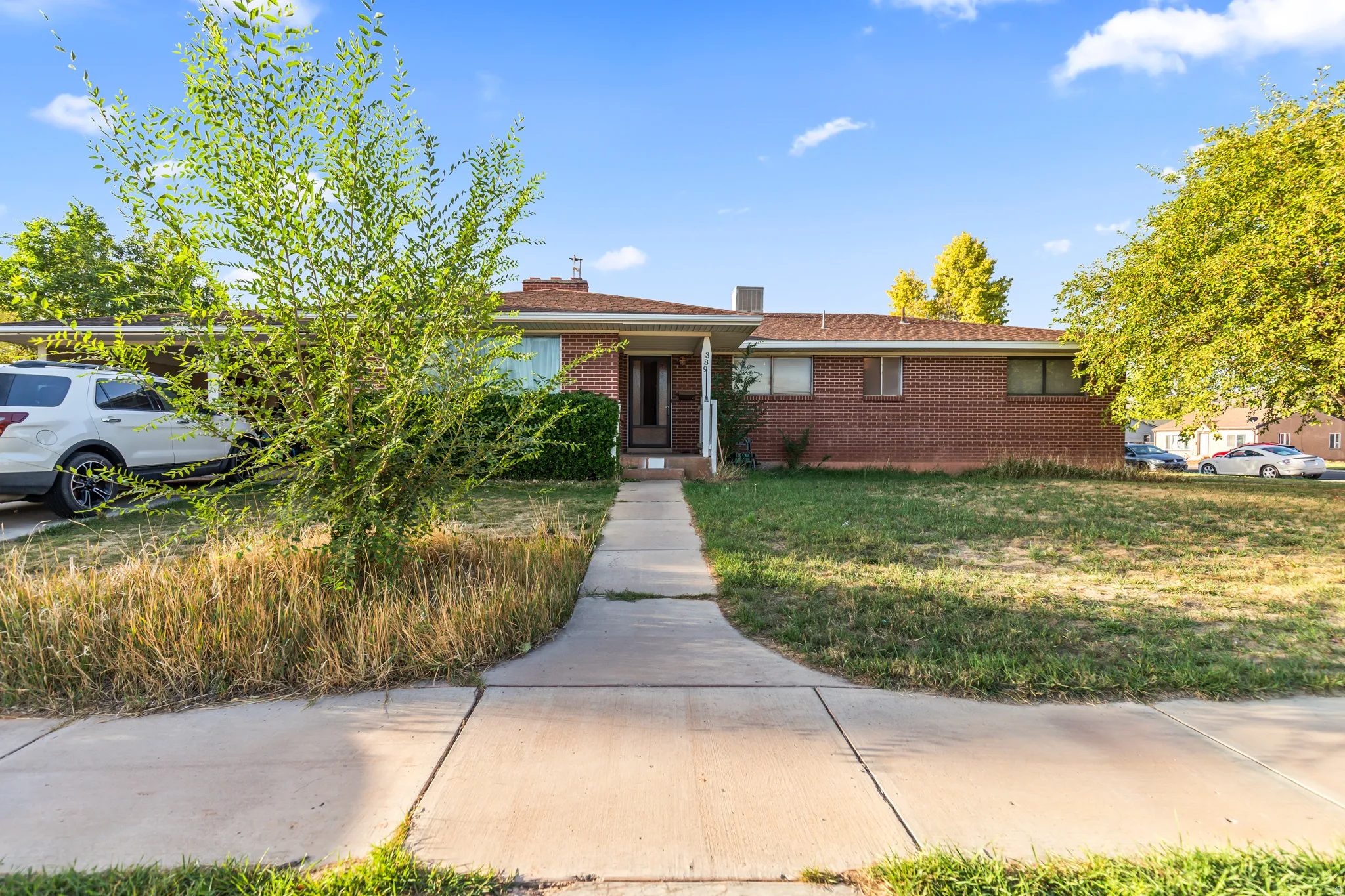 Brick exterior with an attached carport