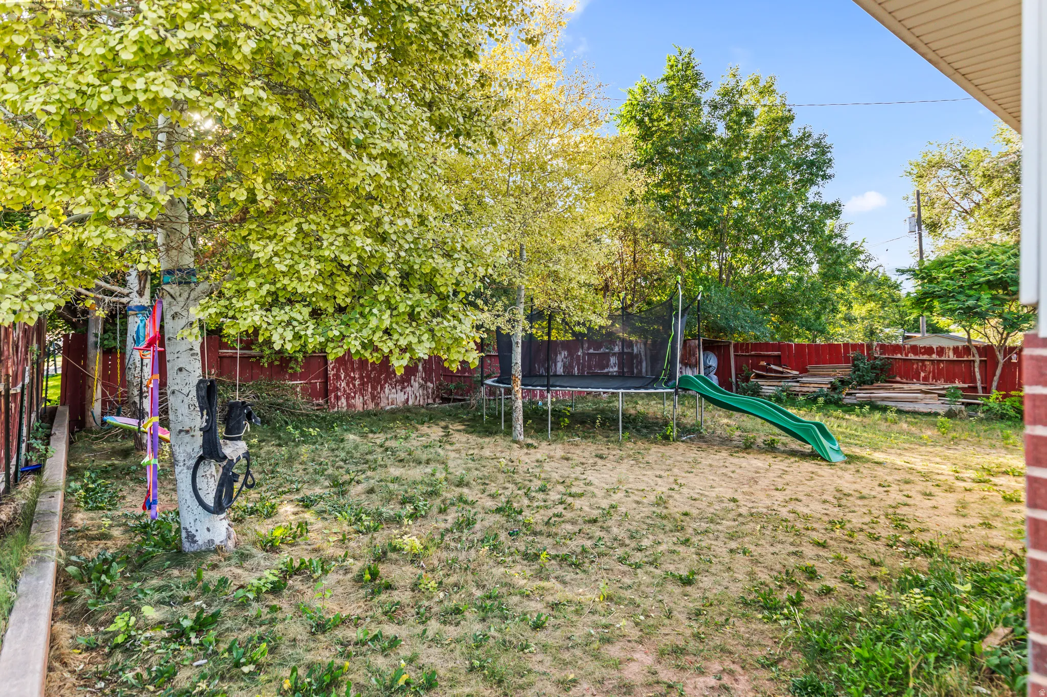 Fenced backyard with mature trees