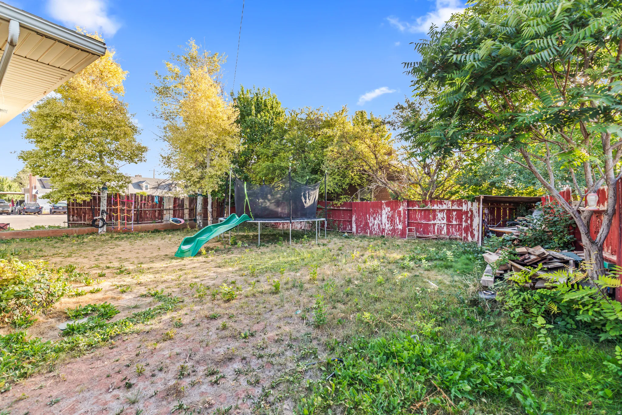 Fenced backyard with mature trees