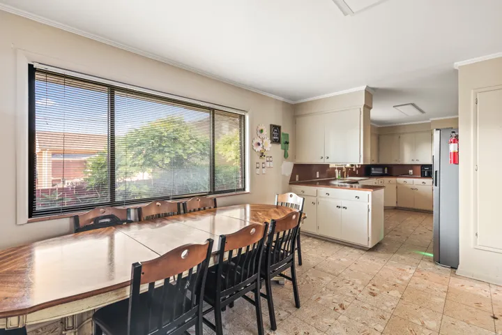 Spacious kitchen featuring neutral cabinetry, integrated appliances, and light-toned flooring