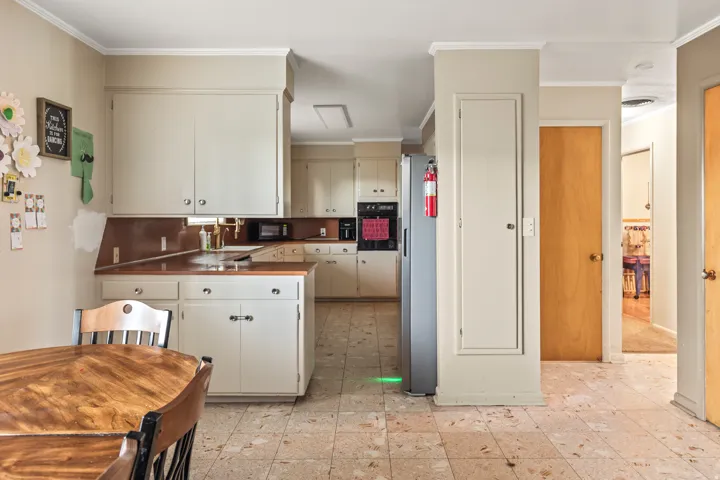 Kitchen featuring extensive cabinetry, integrated wall oven, and built-in microwave