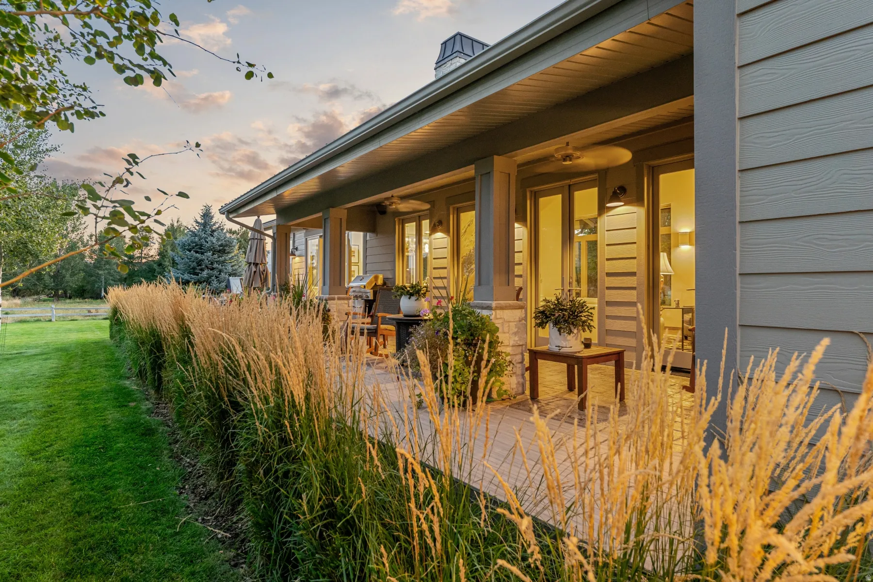 Expansive covered patio featuring a stone accent wall, recessed lighting, and direct access to the interior