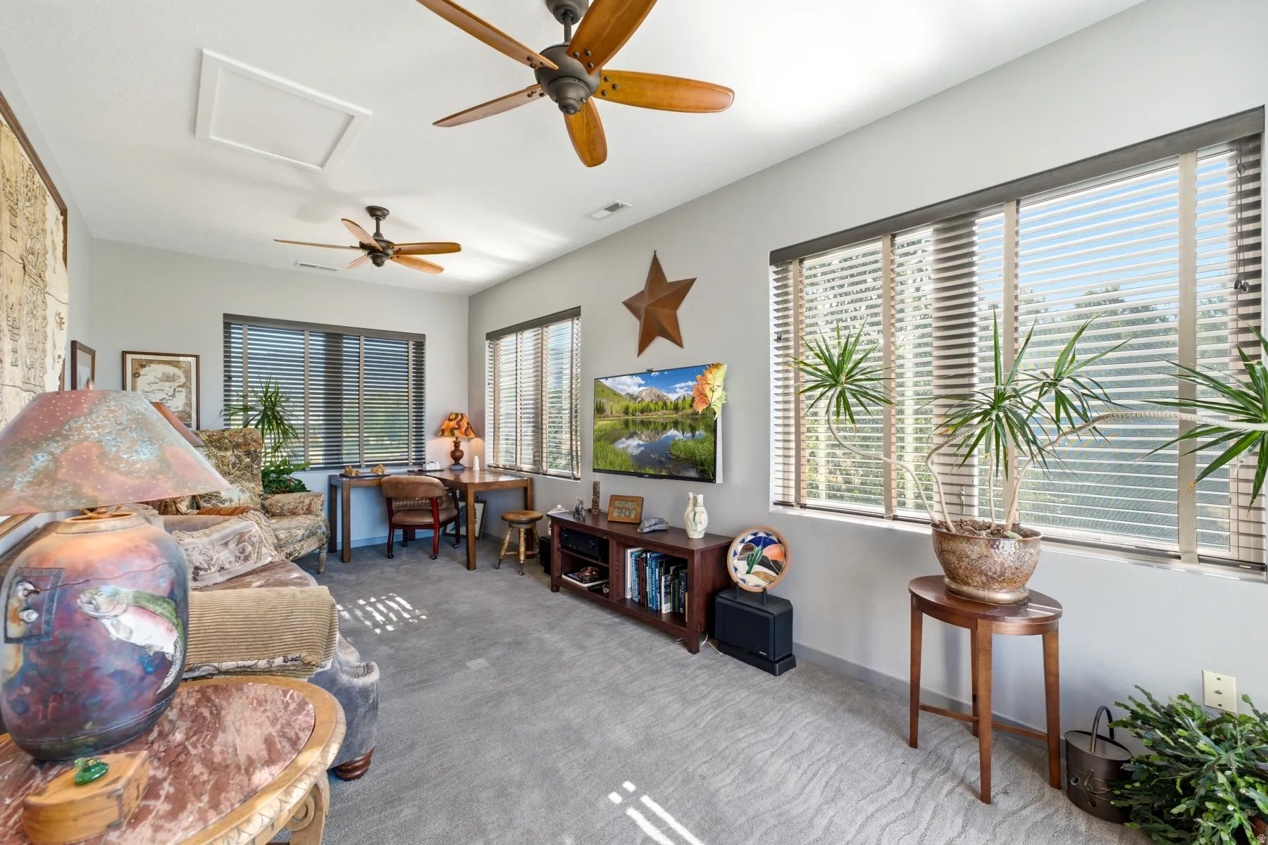 Recessed lighting, multiple ceiling fans, and a built-in media console