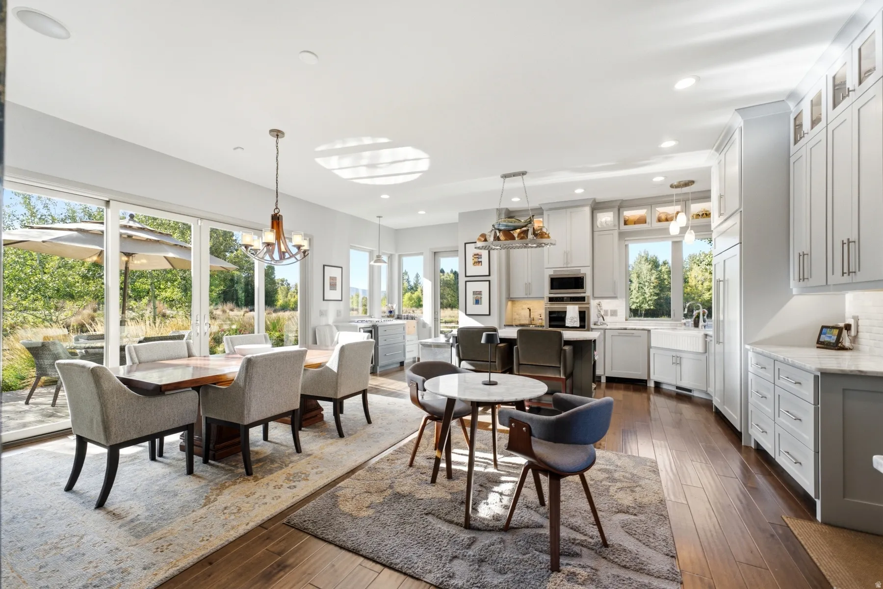 Gourmet kitchen with white cabinetry and stainless steel appliances