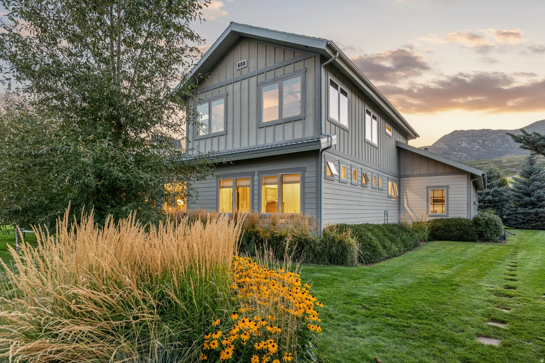 Gray vertical and horizontal siding exterior with multiple windows