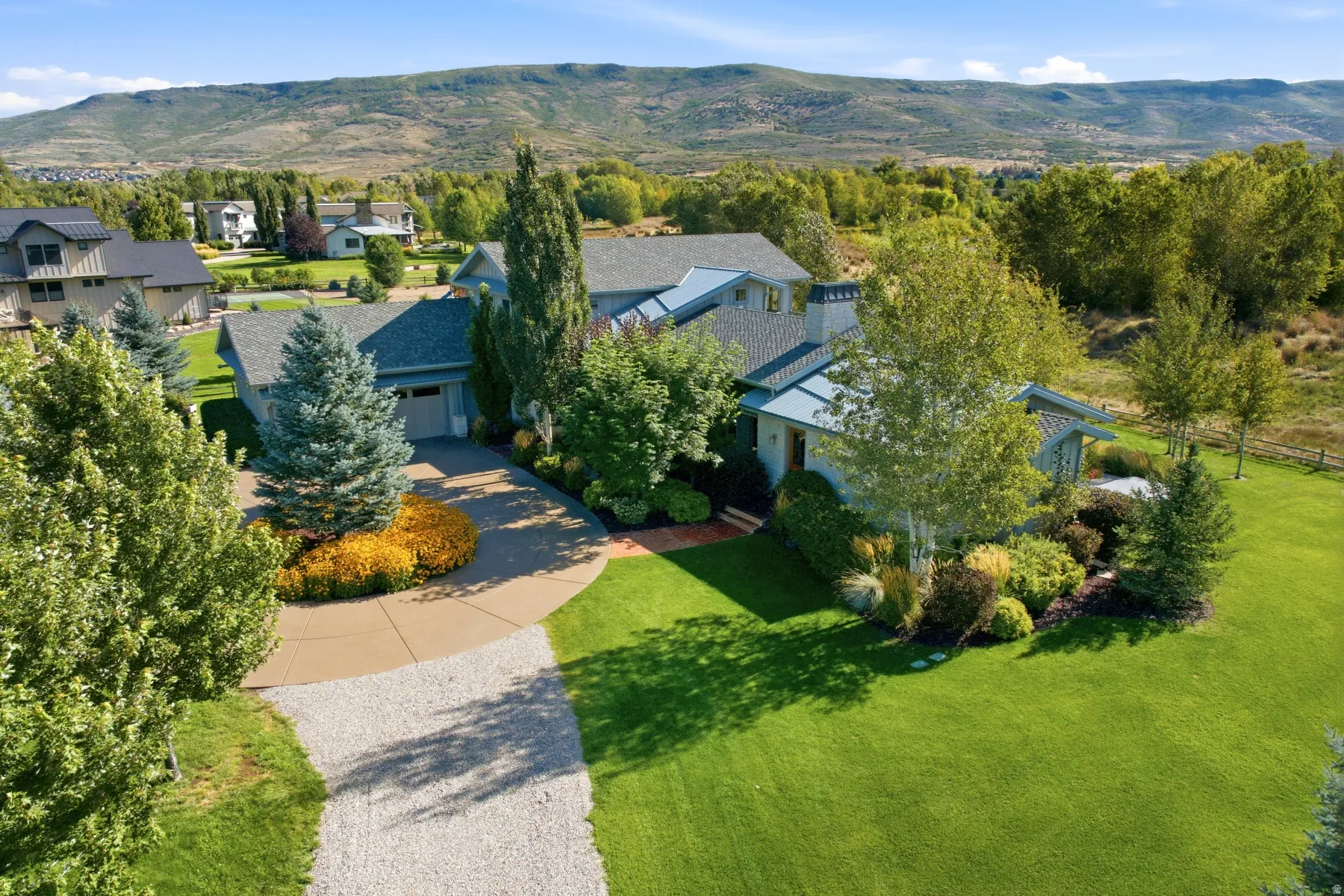 Contemporary architecture with a varied roofline, an integrated garage, and extensive landscaping