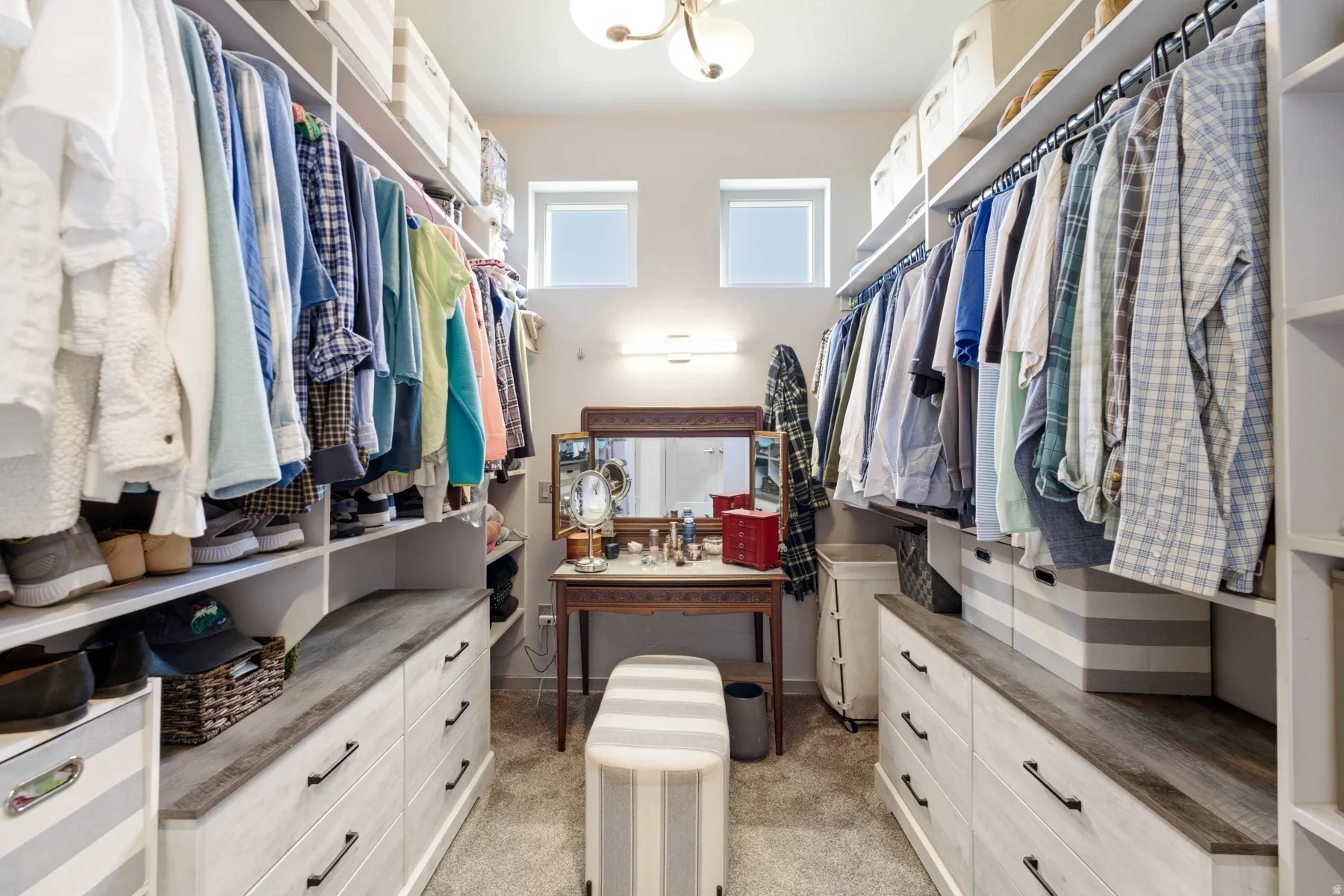 Built-in storage solutions featuring shelving, hanging rods, and integrated drawer units