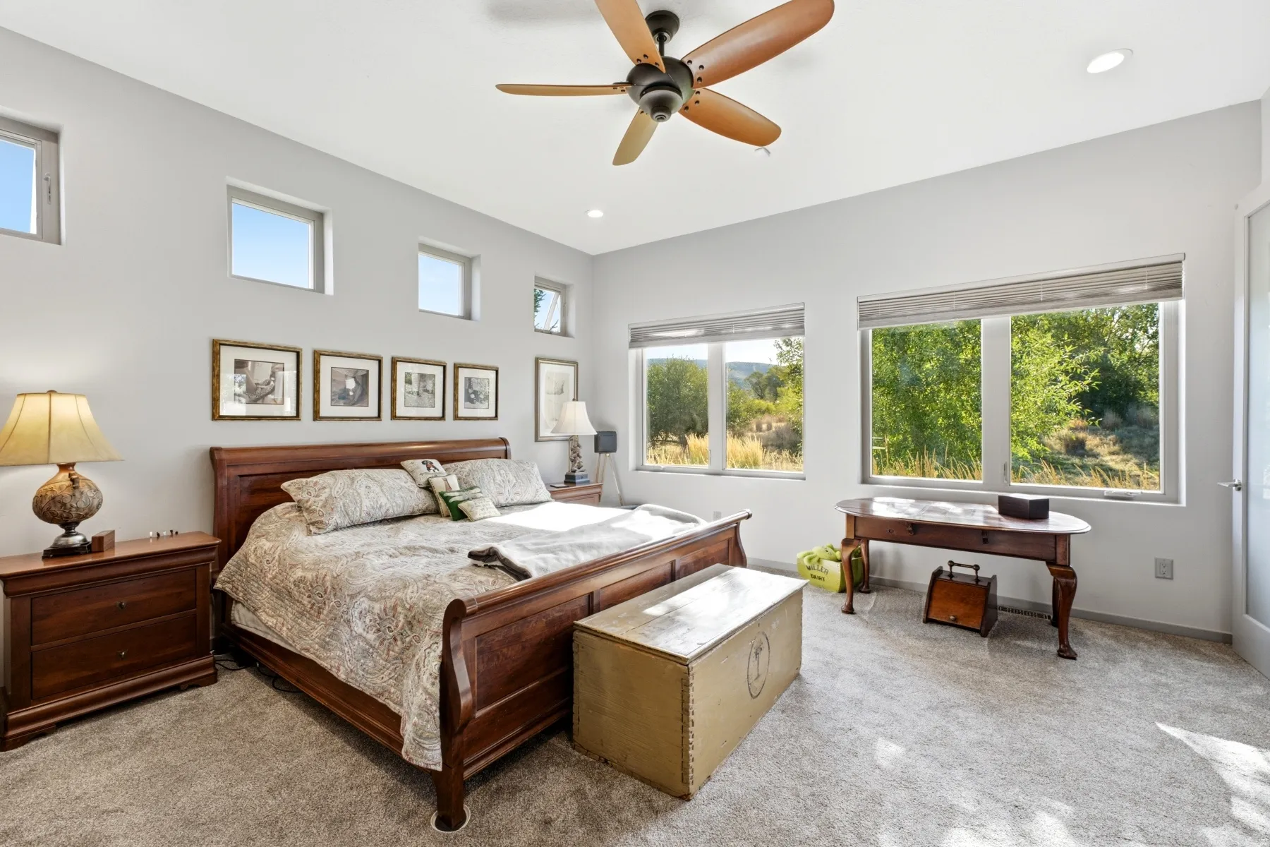 Spacious room featuring multiple large windows, recessed lighting, a ceiling fan, and carpeted flooring
