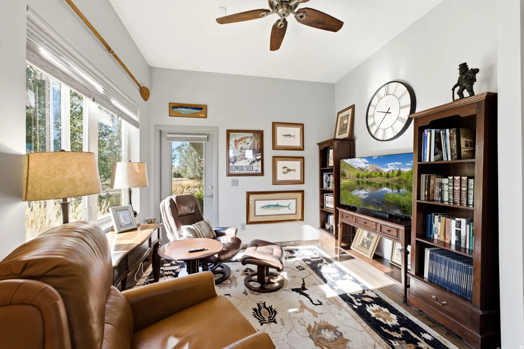 Recessed lighting, wood-finish flooring, ceiling fan, large window with blinds, and glass-paneled exterior door