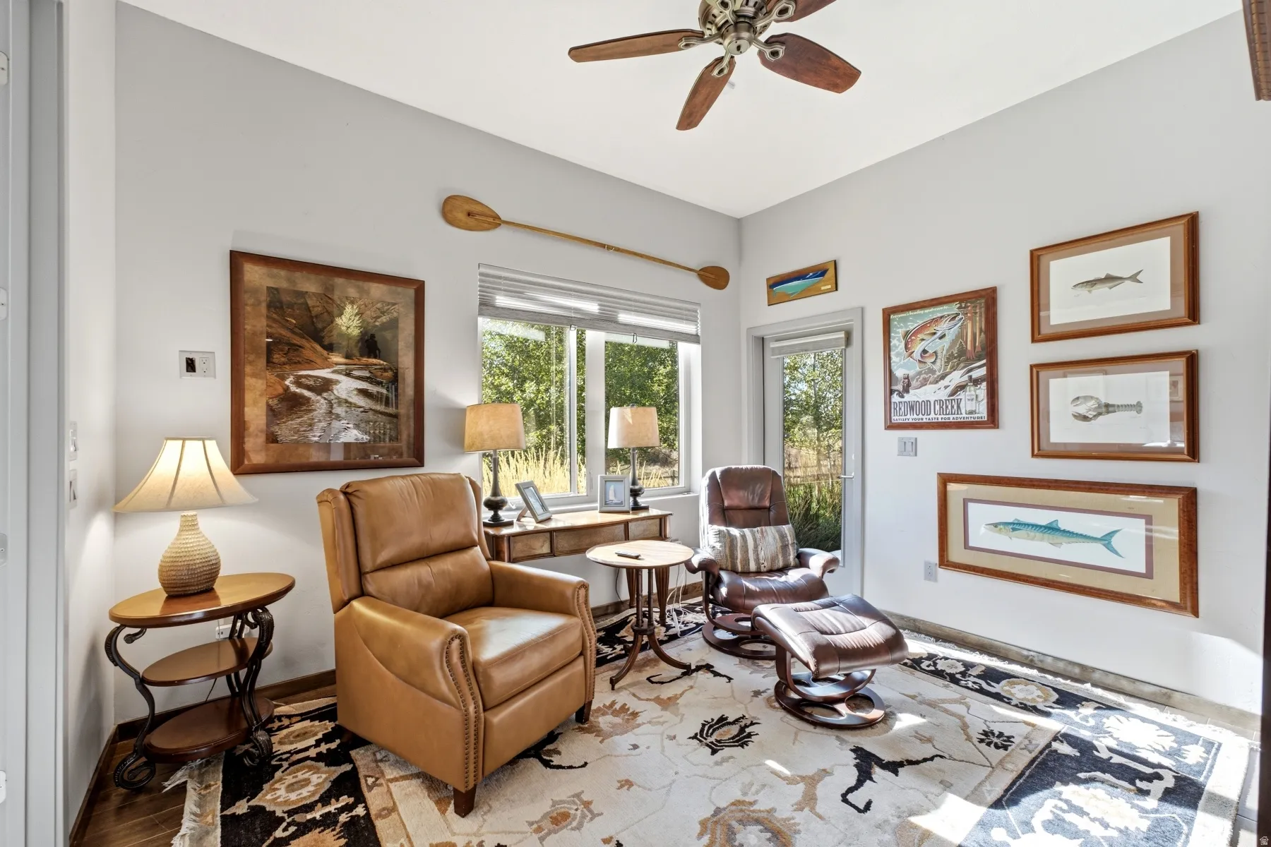 Recessed lighting and a ceiling fan fixture complement the natural light
