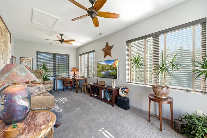 Recessed lighting, multiple ceiling fans, and a built-in media console