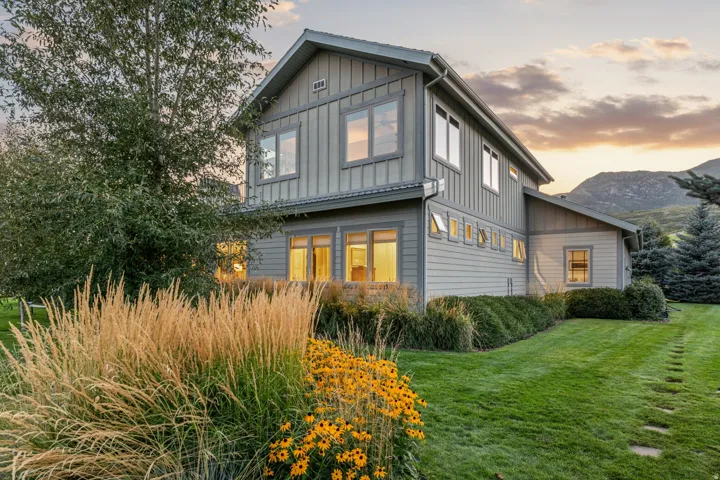 Gray vertical and horizontal siding exterior with multiple windows