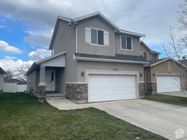 Two-story stucco exterior with stone veneer accents