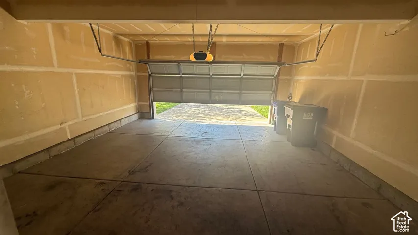 Attached garage with concrete flooring and an automatic garage door opener