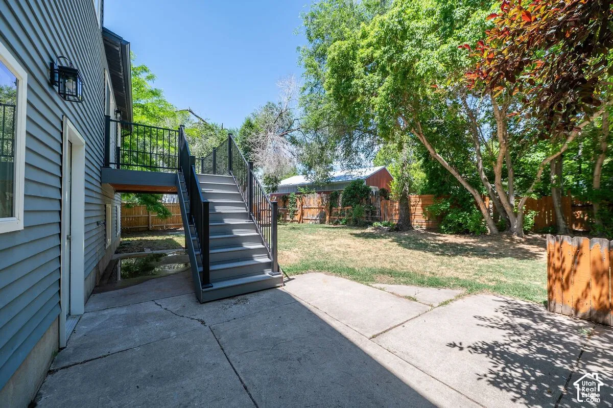 Exterior siding with an attached outdoor staircase, featuring metal railings