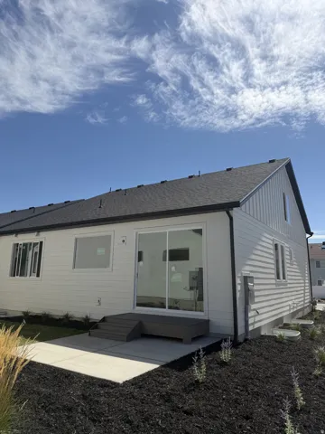 White horizontal siding and vertical accent siding exterior with a dark shingle roof