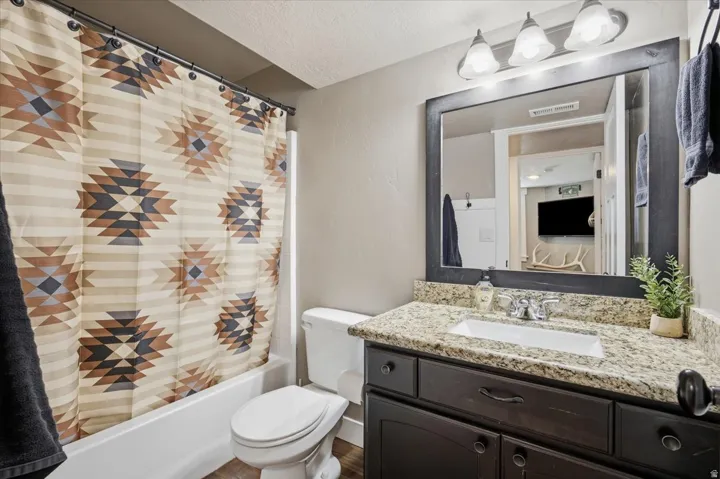 Dark wood-finish vanity with a light-colored granite countertop