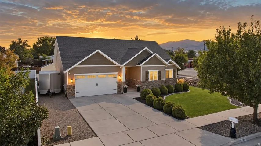 Exterior with stone accents, horizontal siding, and a gabled roof