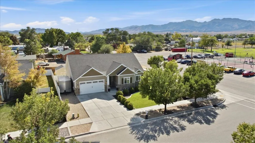 Single-story residence featuring a two-car garage and a paved driveway