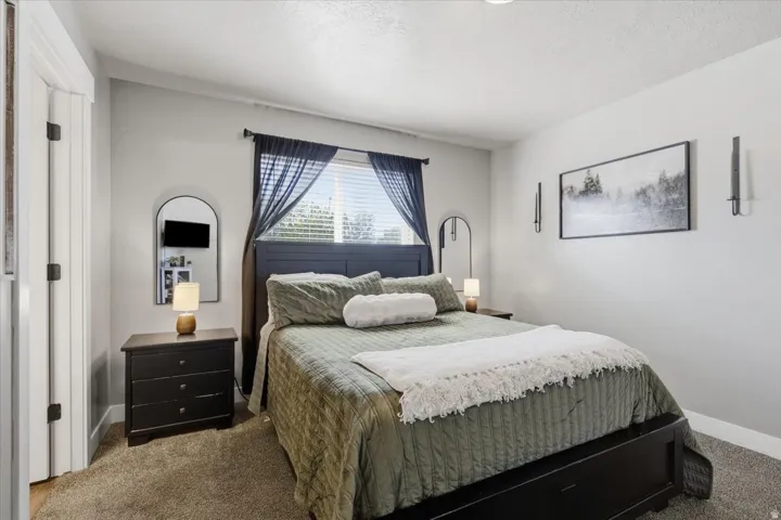 White walls with a window featuring blinds and dark drapery
