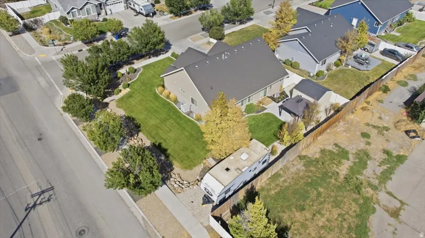 Single-story residence with a dark shingled roof and tan siding