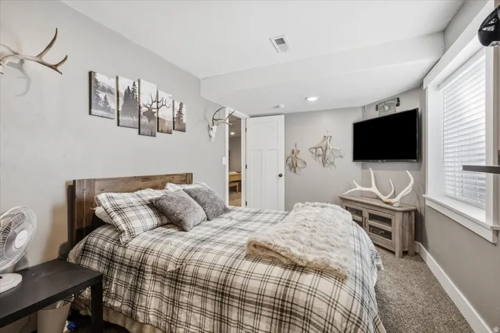 Recessed ceiling lighting, white painted trim, and light gray wall paint