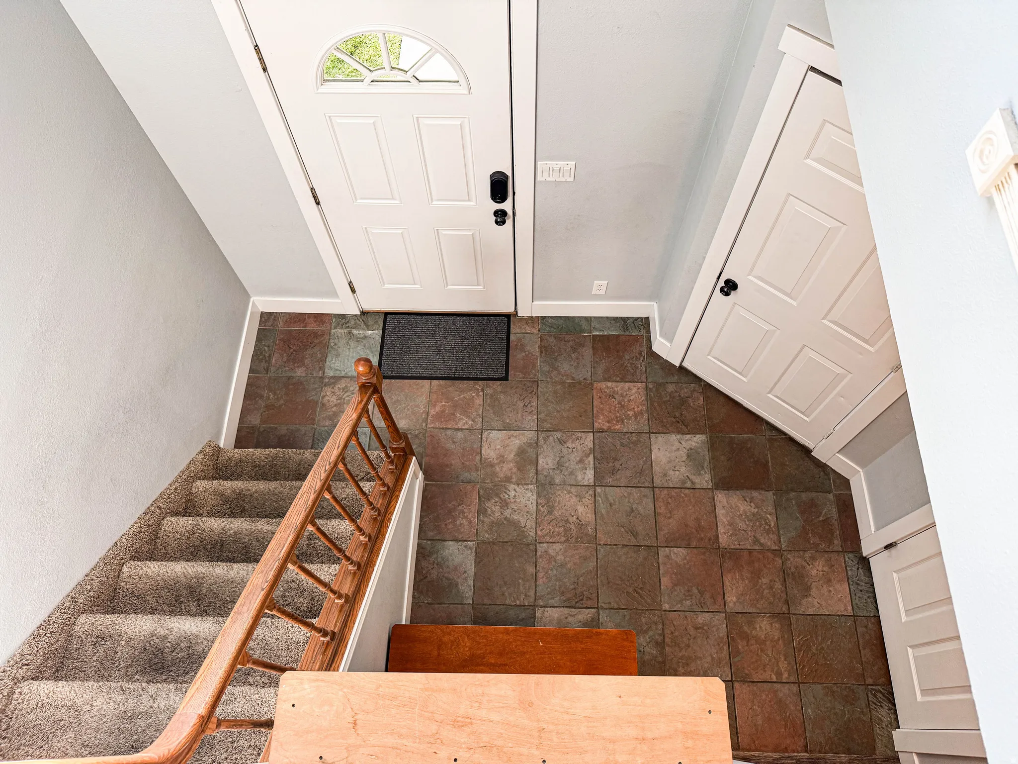 Entryway featuring multi-toned tile flooring