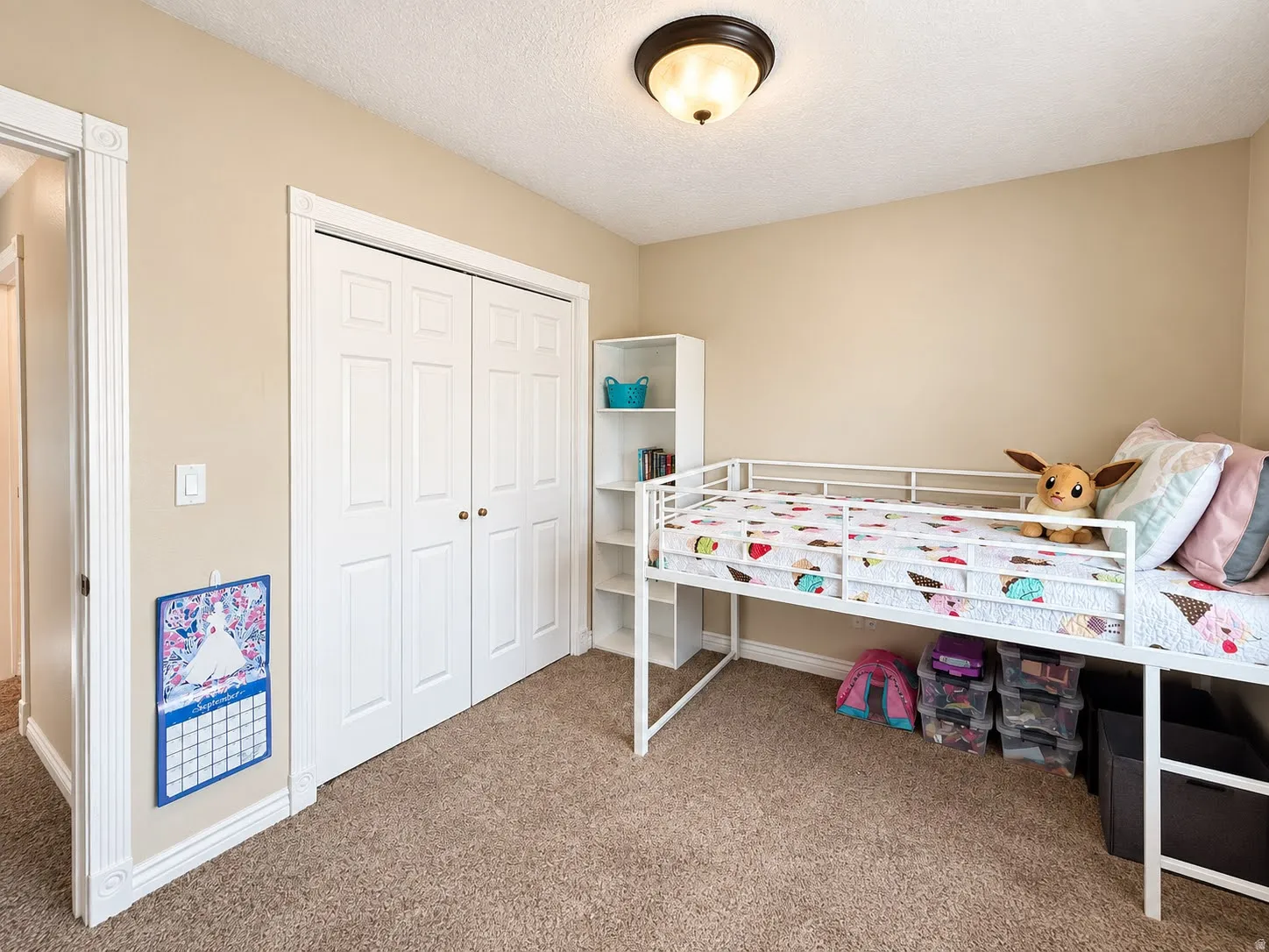 Recessed lighting, neutral wall paint, and carpeted flooring