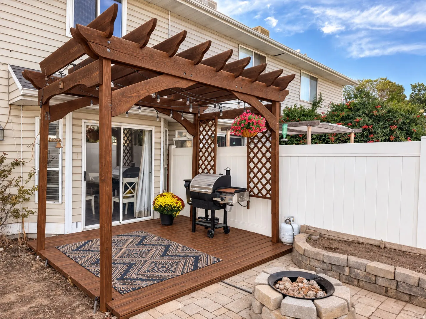 Outdoor deck featuring a wood pergola and lattice accents
