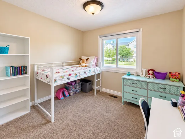 Neutral-toned walls complement plush carpeting