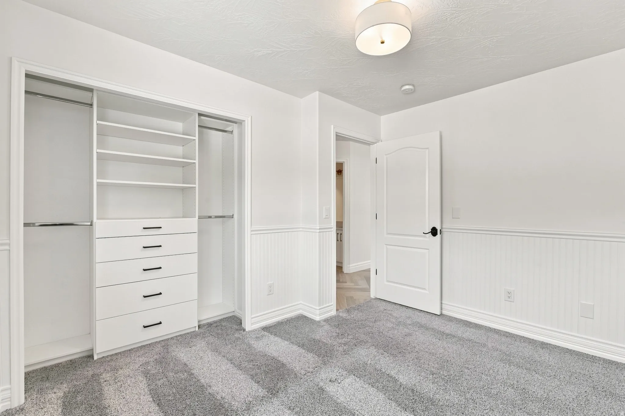 Built-in closet organization system with shelving and drawers